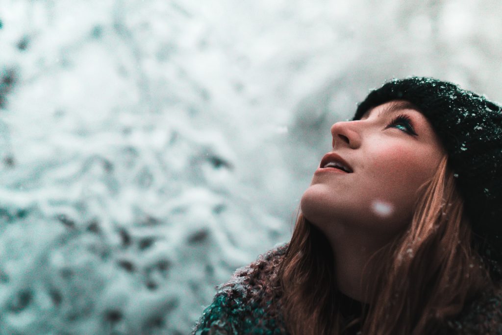 Photo by Joe Yates on Unsplash Woman looking into snow to set soul aligned goals