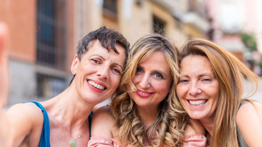 signs of perimenopause in women. Three women posing for a photo.