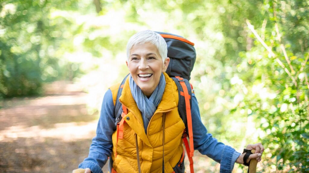 happy older woman hiking in perimenopause. symptoms of perimenopause.